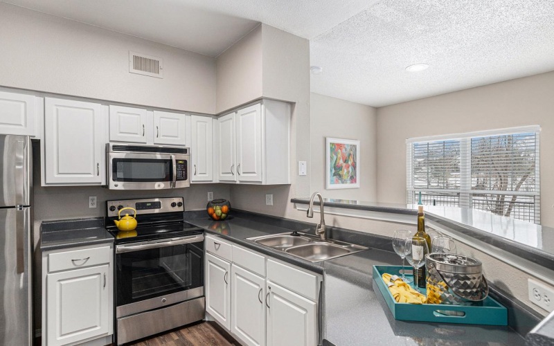 a kitchen with white cabinets